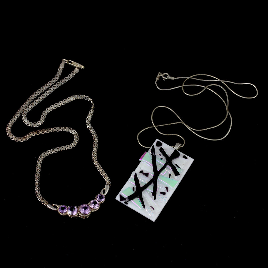 TWO SILVER NECKLACES.
