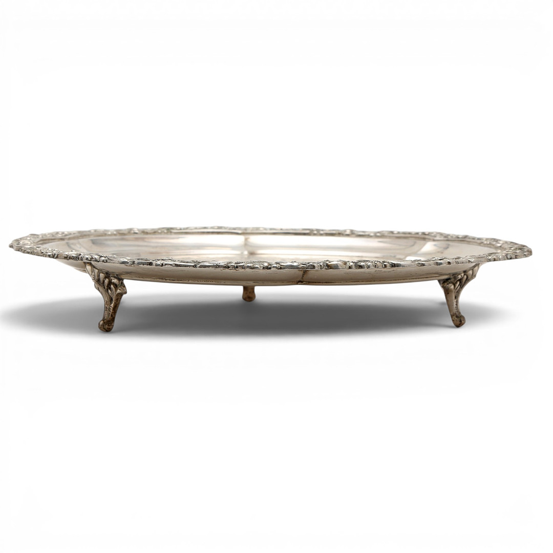 Embossed and chiselled silver salver, mid 20th Century.