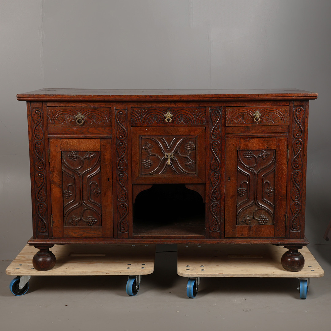 A 19TH CENTURY OAK SIDEBOARD SET WITH 15TH CENTURY OAK PANELS.