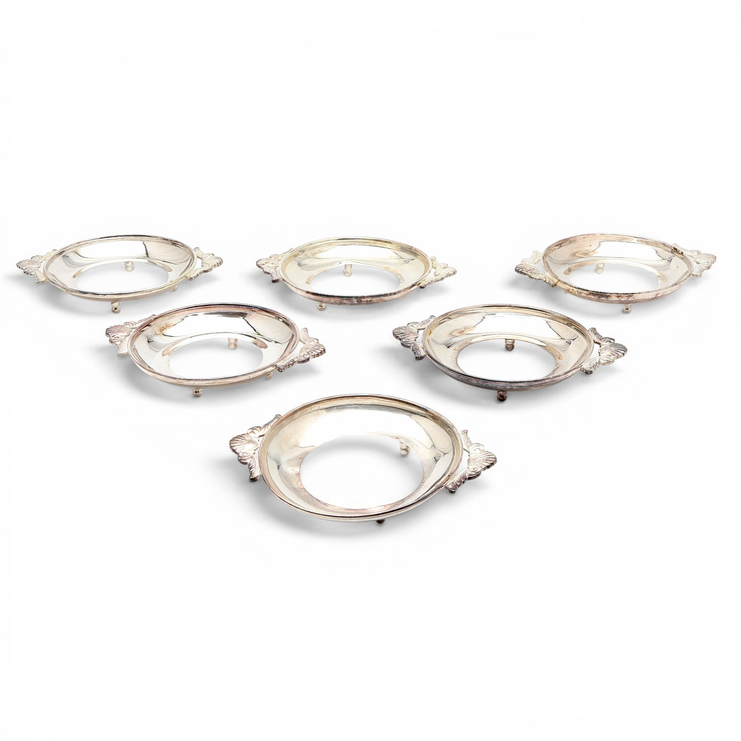 Set of six dish holders in silvery metal, mid 20th Century.