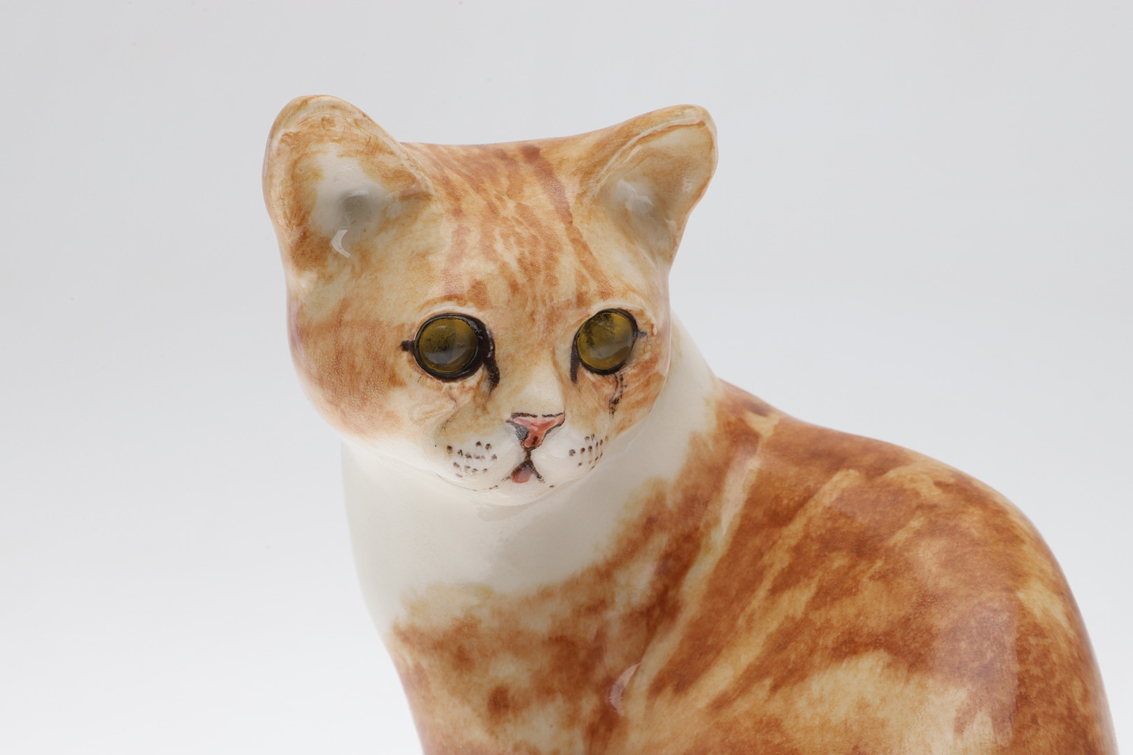 A WINSTANLEY POTTERY SEATED GINGER CAT.