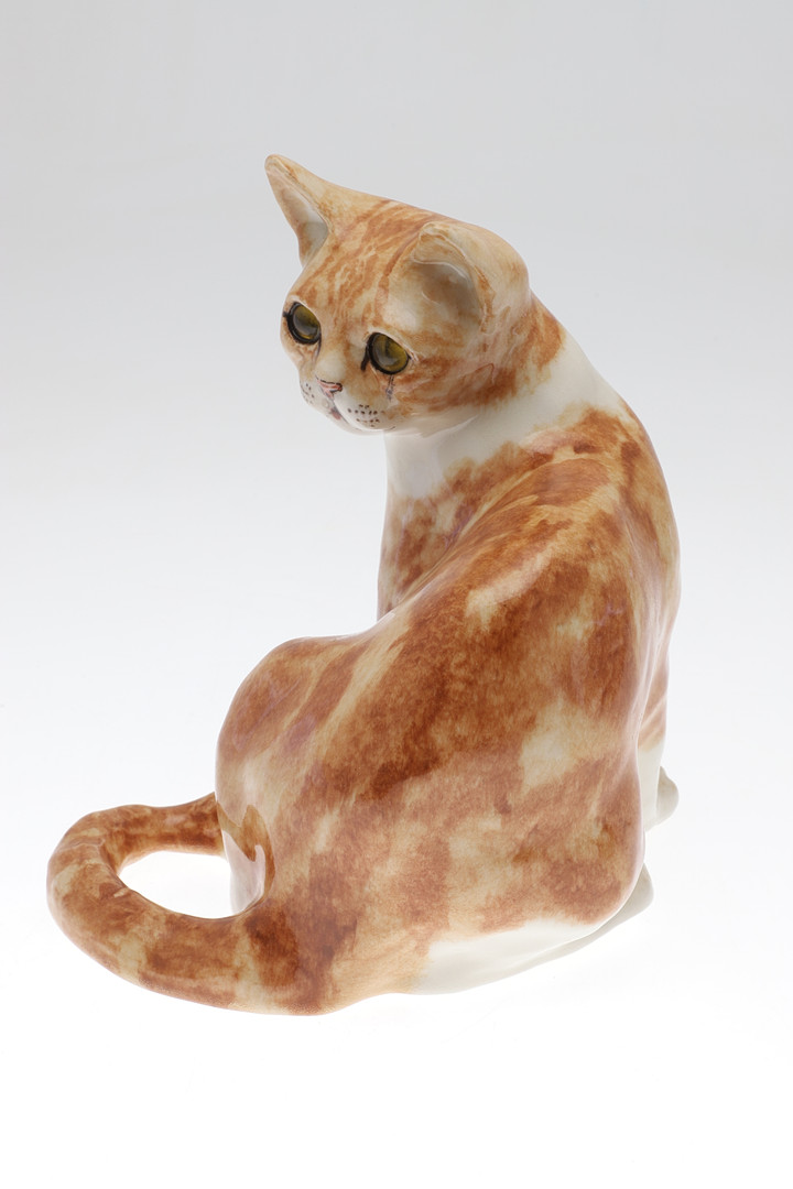 A WINSTANLEY POTTERY SEATED GINGER CAT.