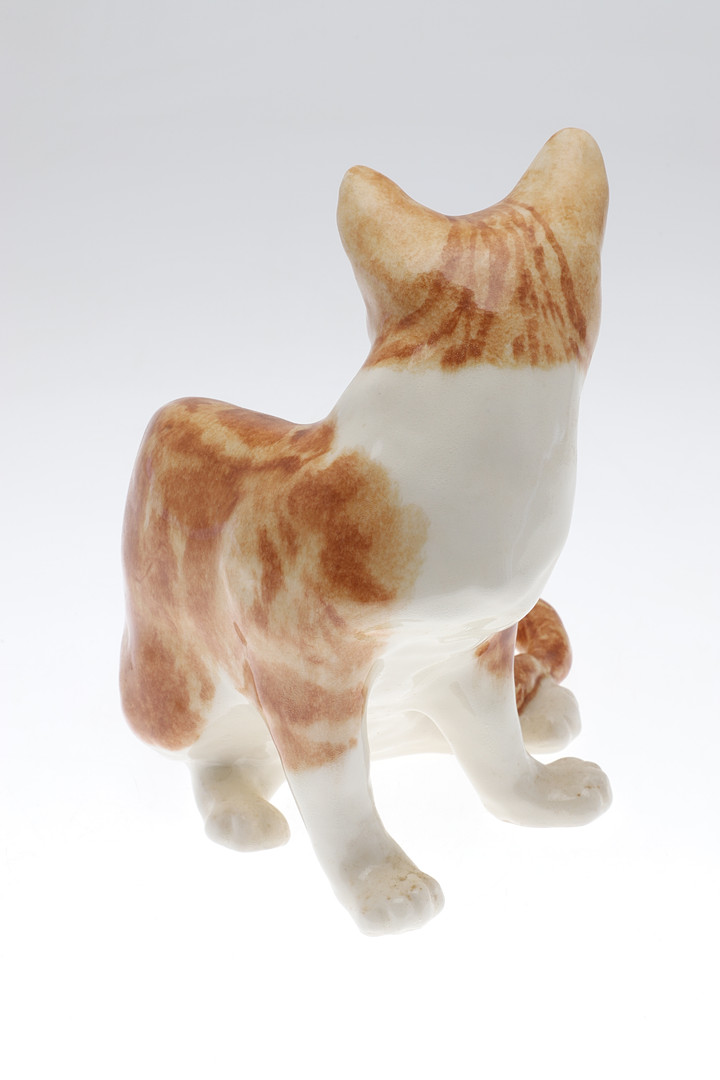A WINSTANLEY POTTERY SEATED GINGER CAT.