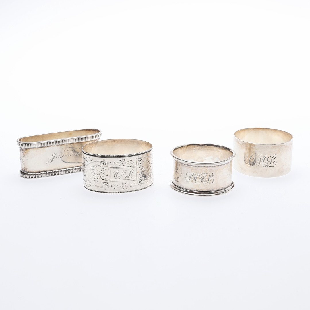4 SILVER NAPKIN RINGS.