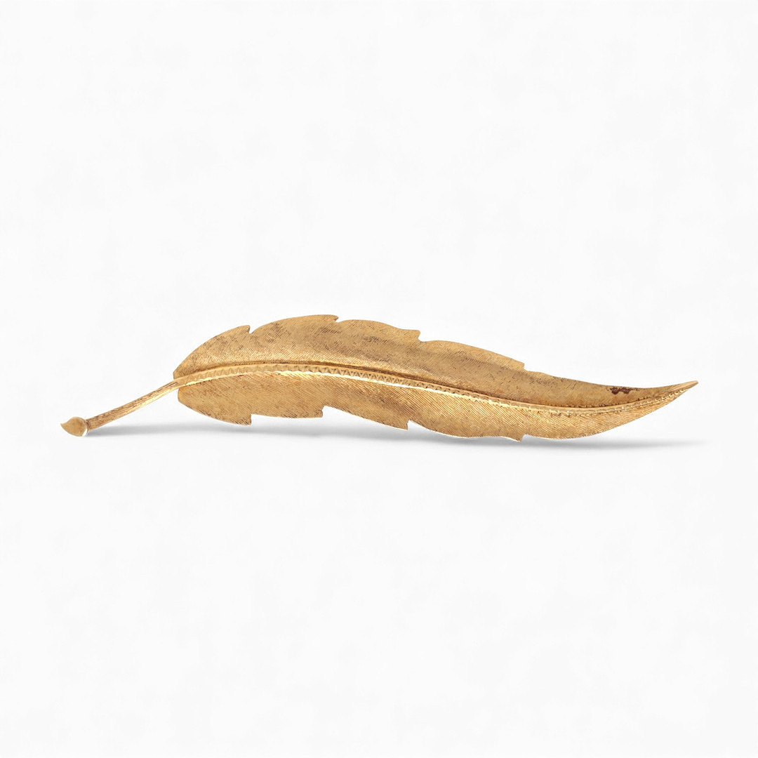 Matte finish leaf-shaped brooch.