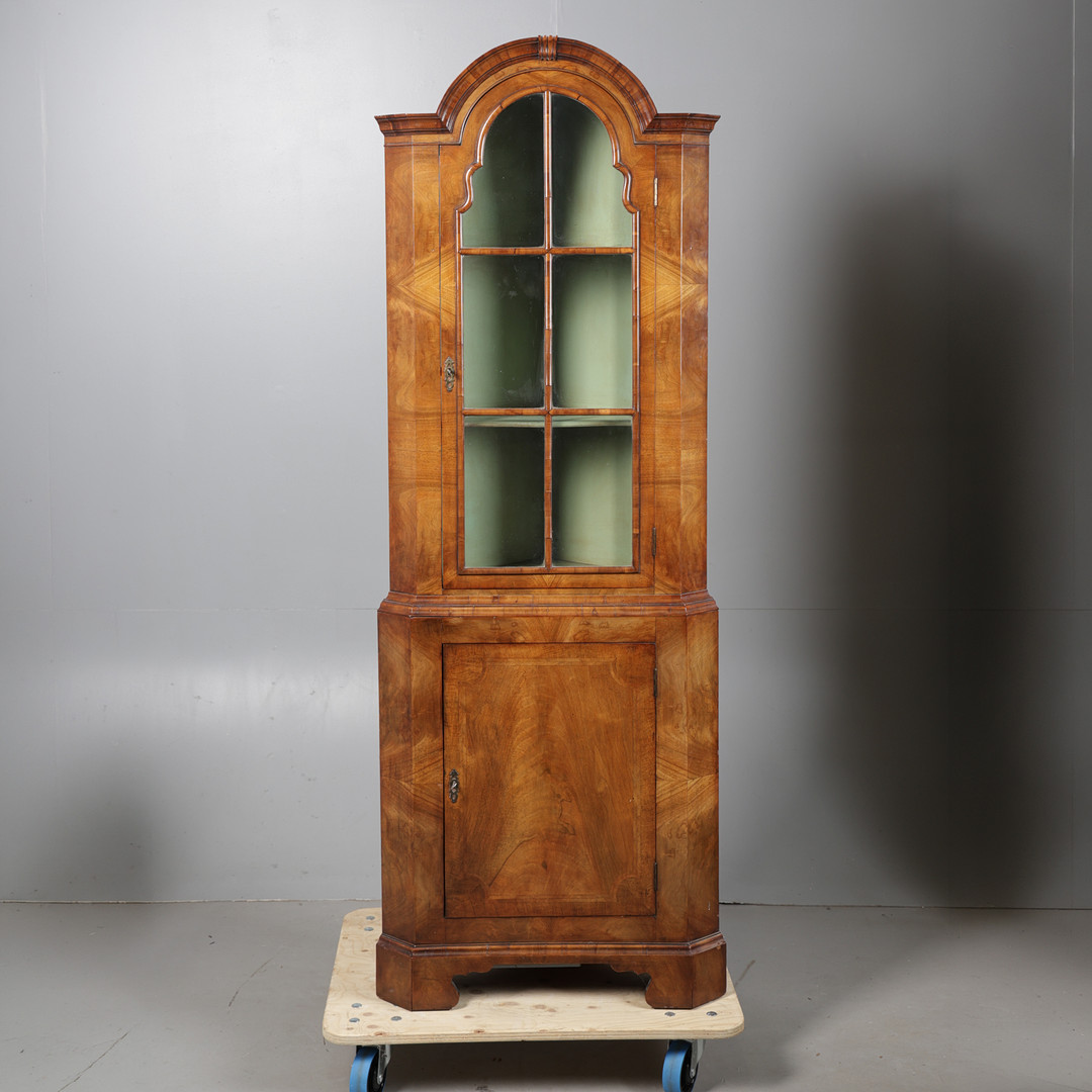 A GEORGE III STYLE WALNUT CORNER CUPBOARD.