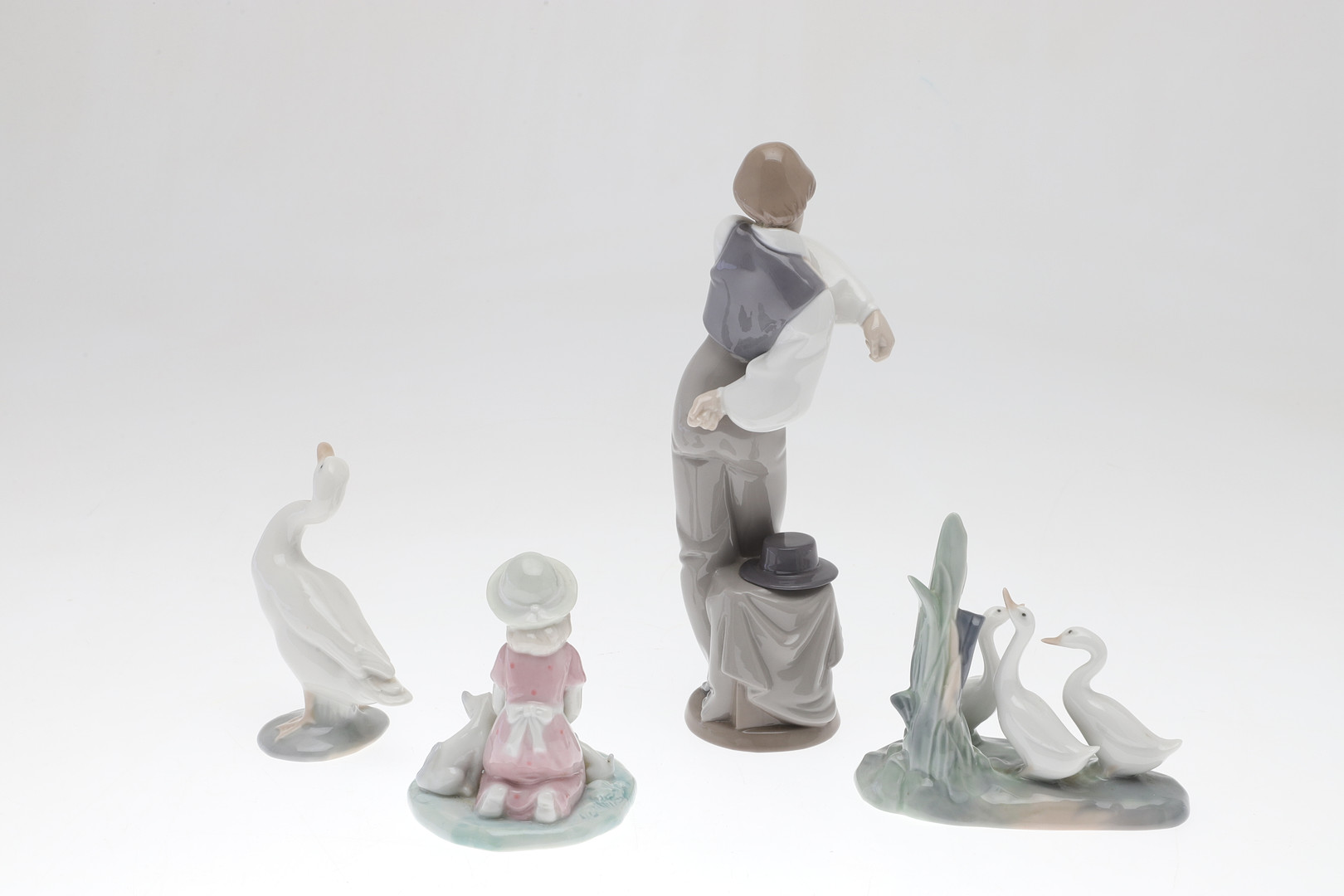 FOUR PORCELAIN FIGURES.