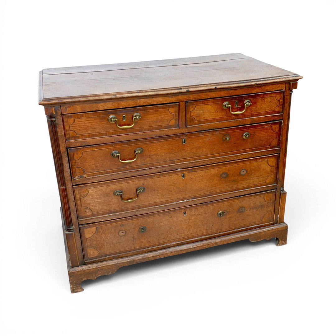 A GEORGE III OAK AND LINE INLAID CHEST.