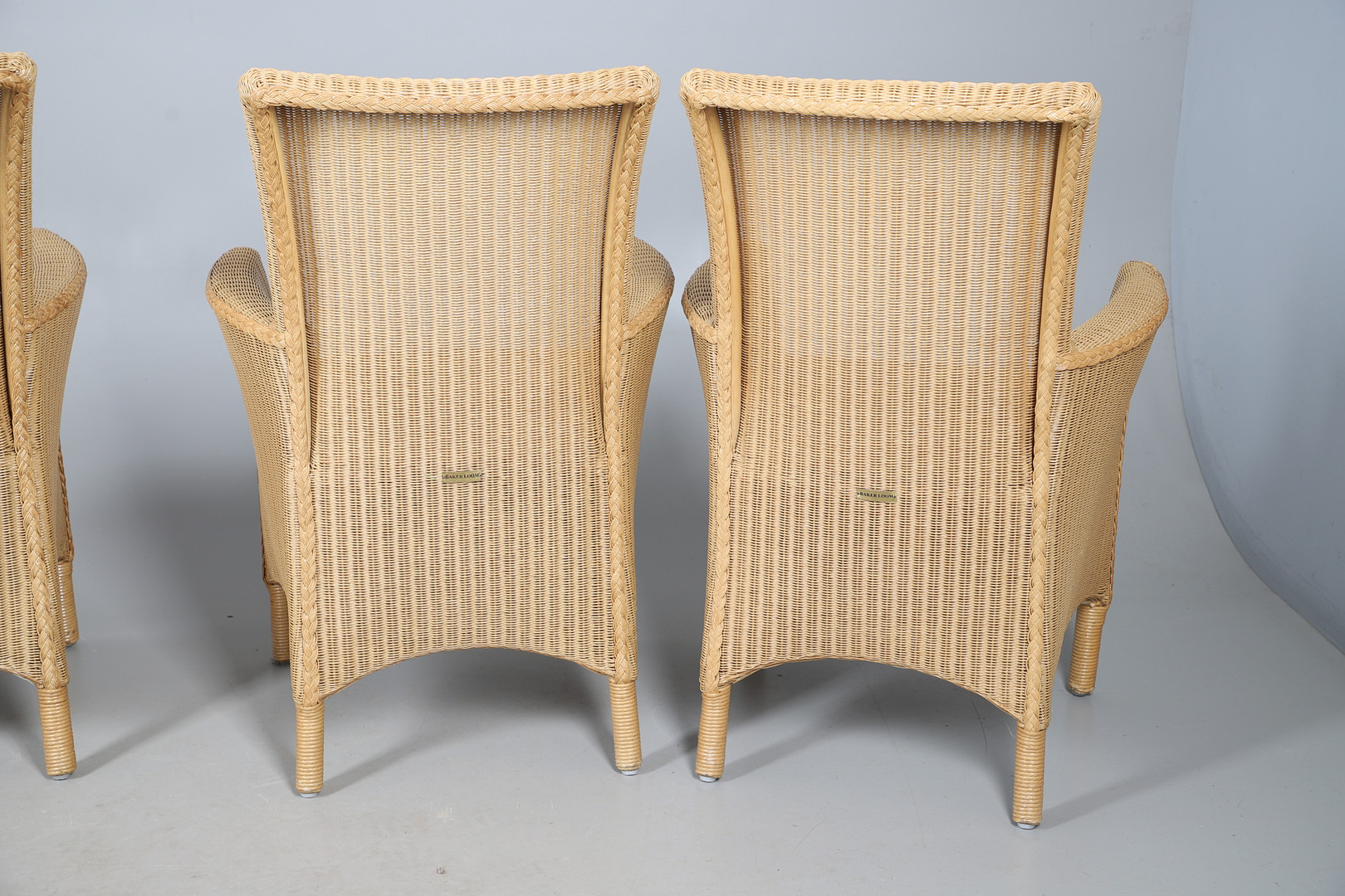 A SET OF FOUR BAKER LOOM WICKER CHAIRS.