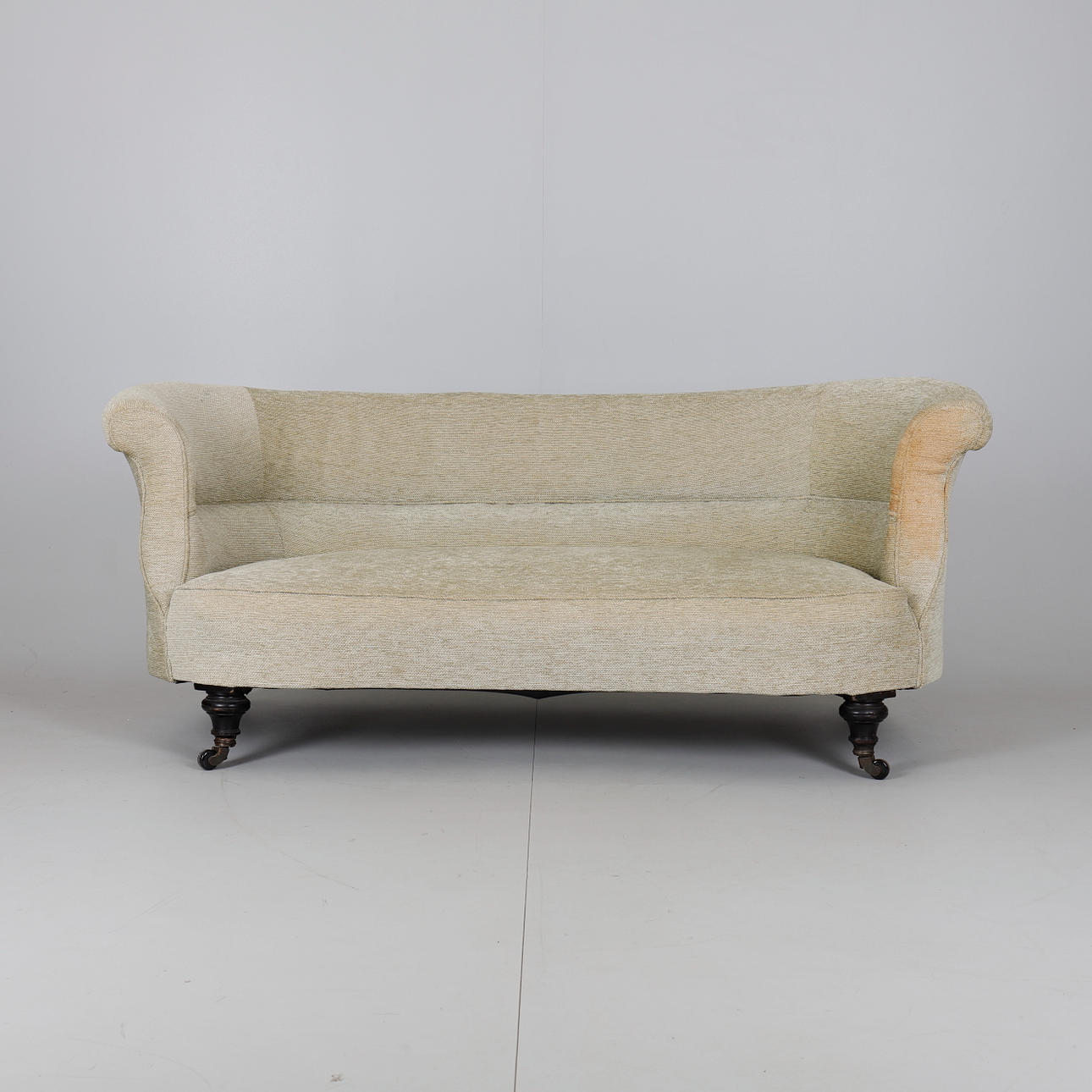 A VICTORIAN EBONISED AND UPHOLSTERED KIDNEY SHAPED SOFA.