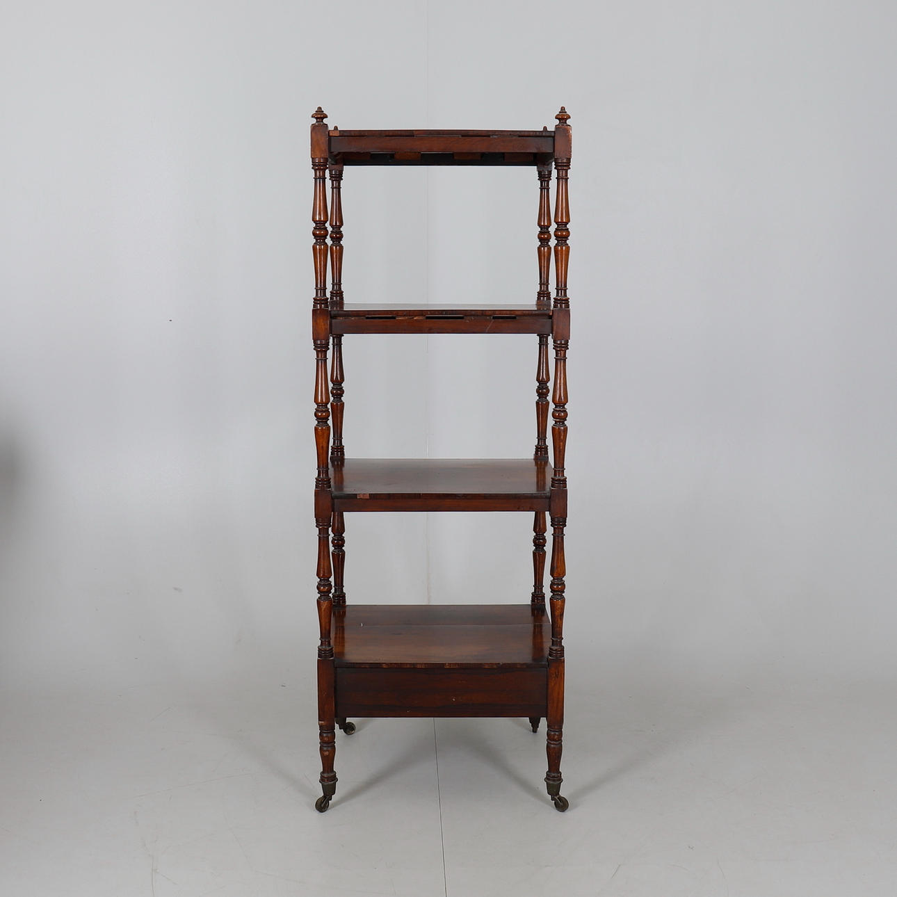 A VICTORIAN ROSEWOOD WHATNOT.