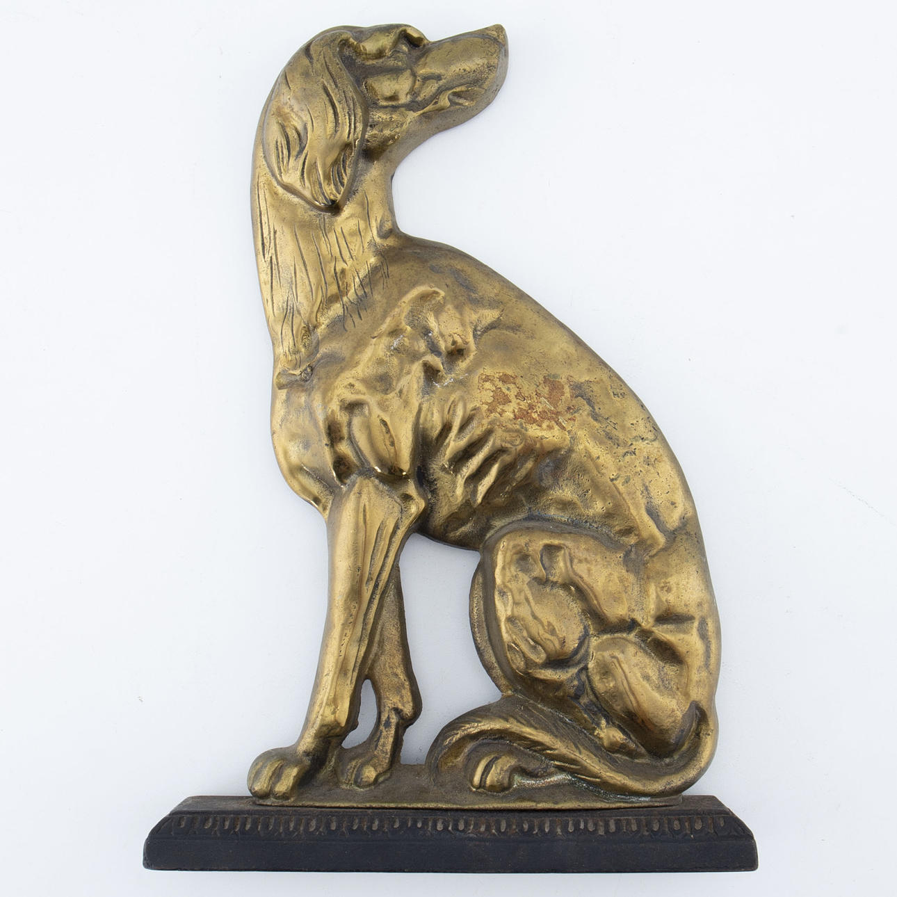 Dog-shaped door stopper in metal.