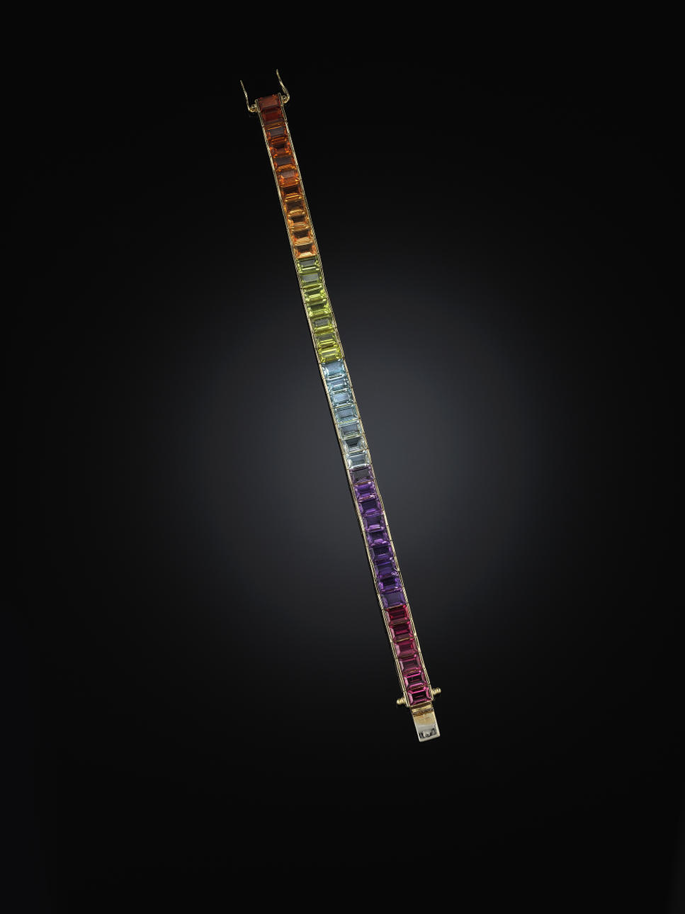 ARMBAND, 18 kt guld, med olika färgstenar (granat, ametist, blå topas, peridot samt citrin). Små skador.