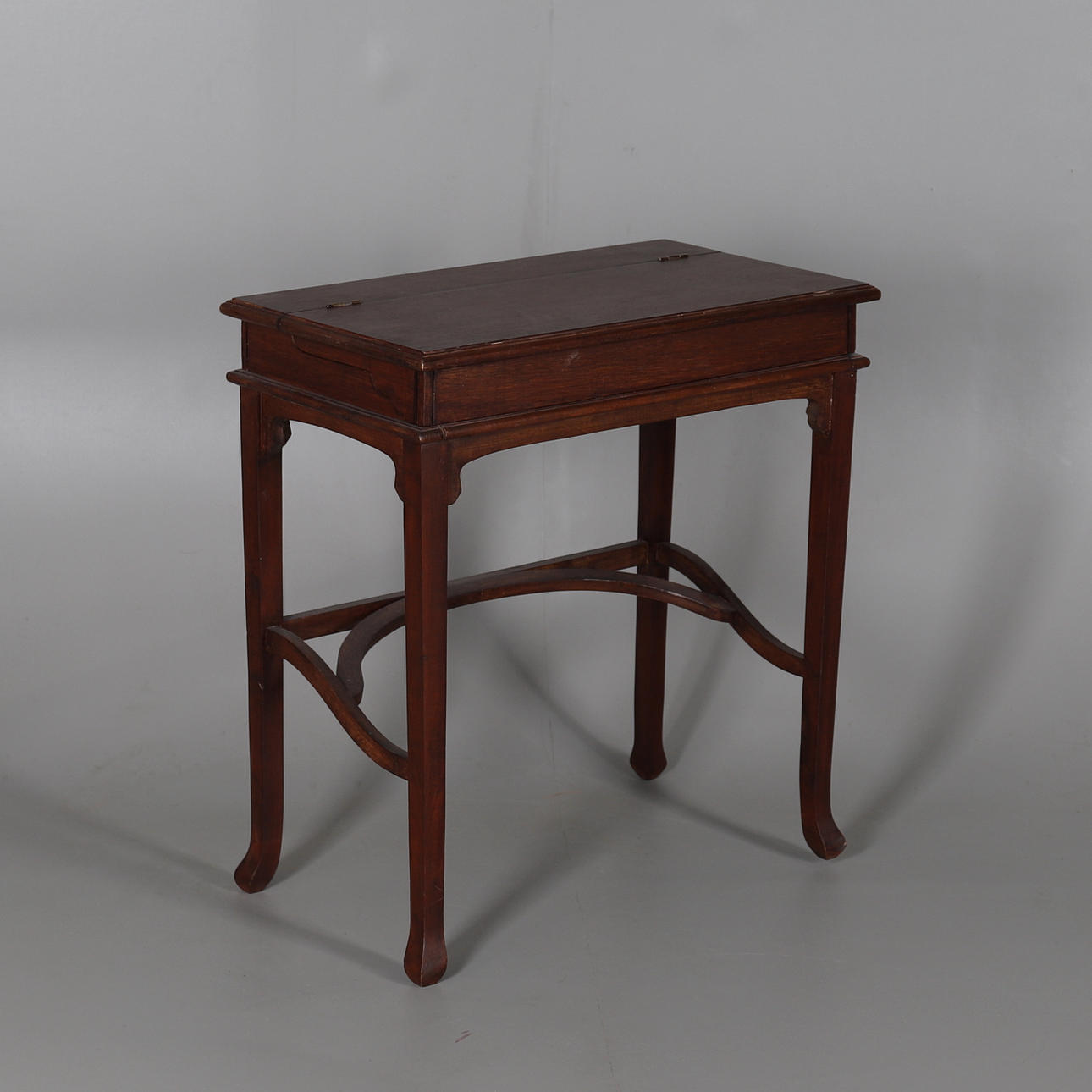 A MAHOGANY-STAINED WRITING DESK.