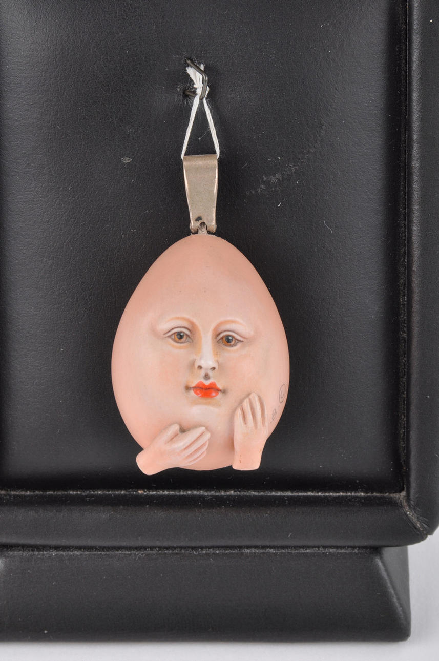 SERGIO BUSTAMANTE. "egg face". Resin pendant.