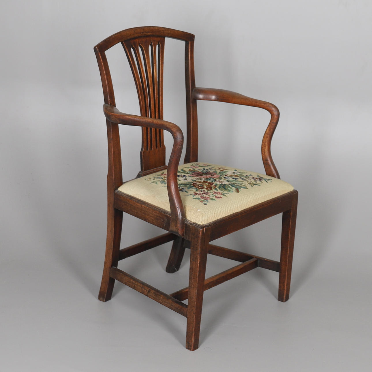 A MAHOGANY FRAMED ELBOW CHAIR.