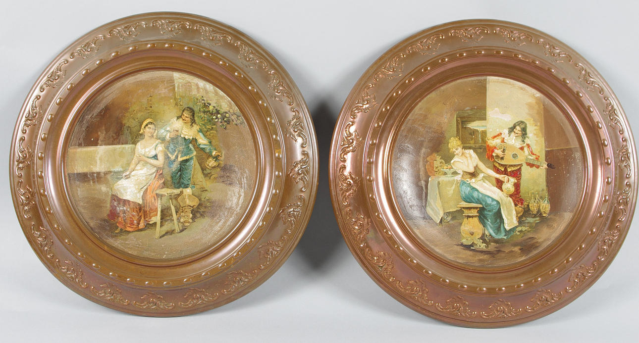 VÄGGRELIEFER, 2 stycken, målade porslinsplattor med kopparram.