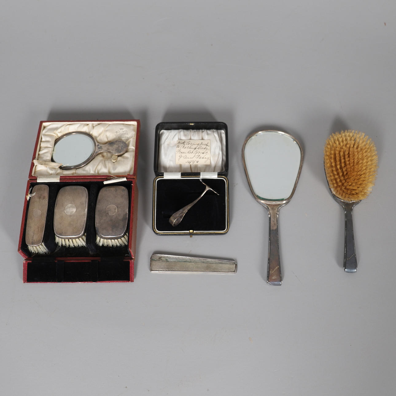 A CASED SILVER BACKED BRUSH AND MIRROR SET.