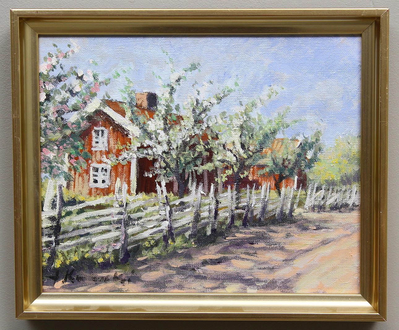 ALEXANDER KUNICKI. Rött hus och blommande fruktträd. Olja på duk. Signerad.