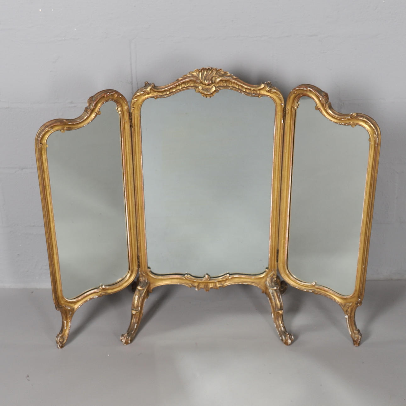 A GILT GESSO FRAMED TRIPLE DRESSING MIRROR.