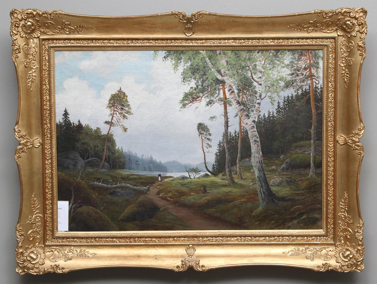 OKÄND KONSTNÄR. Landskap med kvinna på stig. Olja på duk. Signerad och daterad 1887.