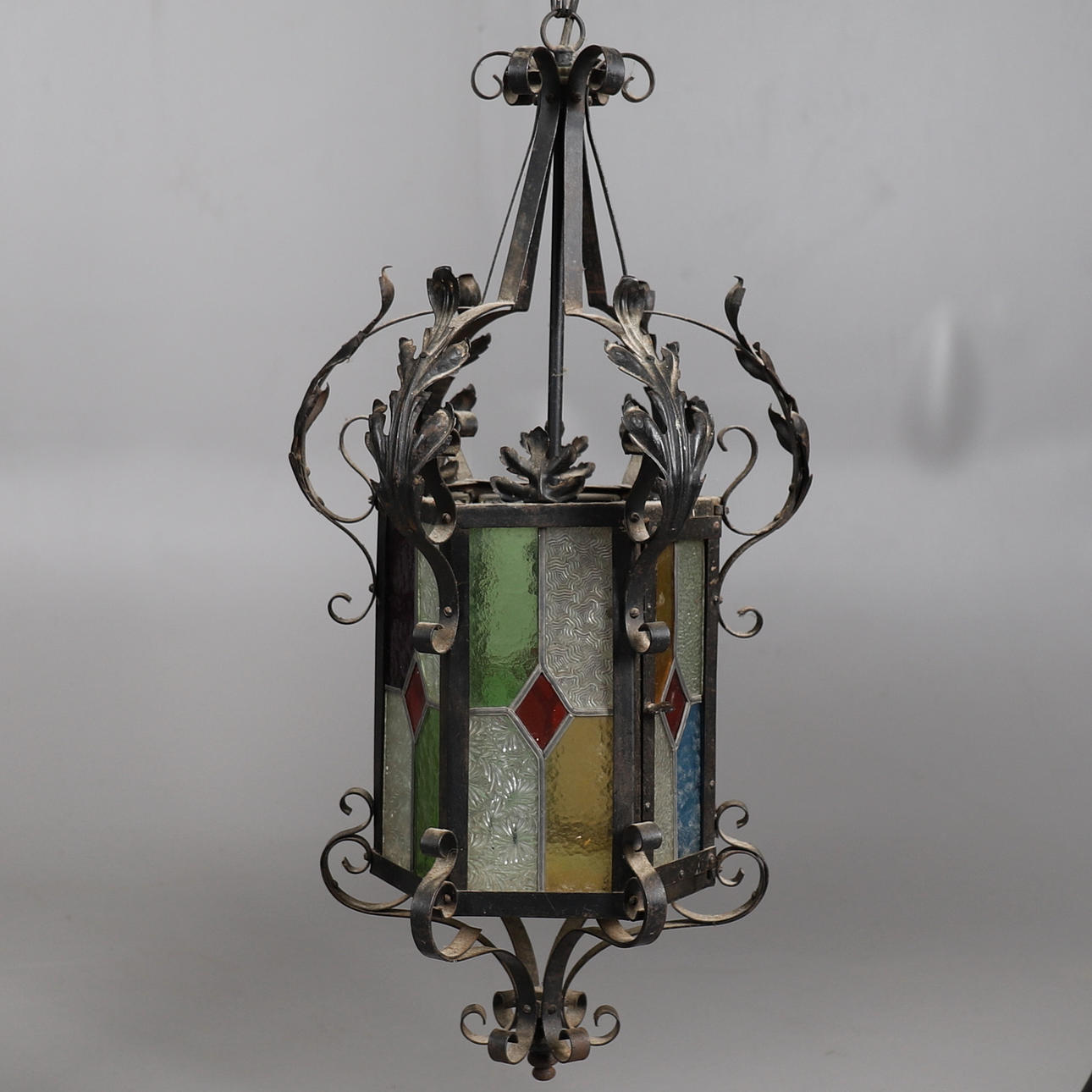 A WROUGHT IRON AND LEADED LIGHT HALL LANTERN.