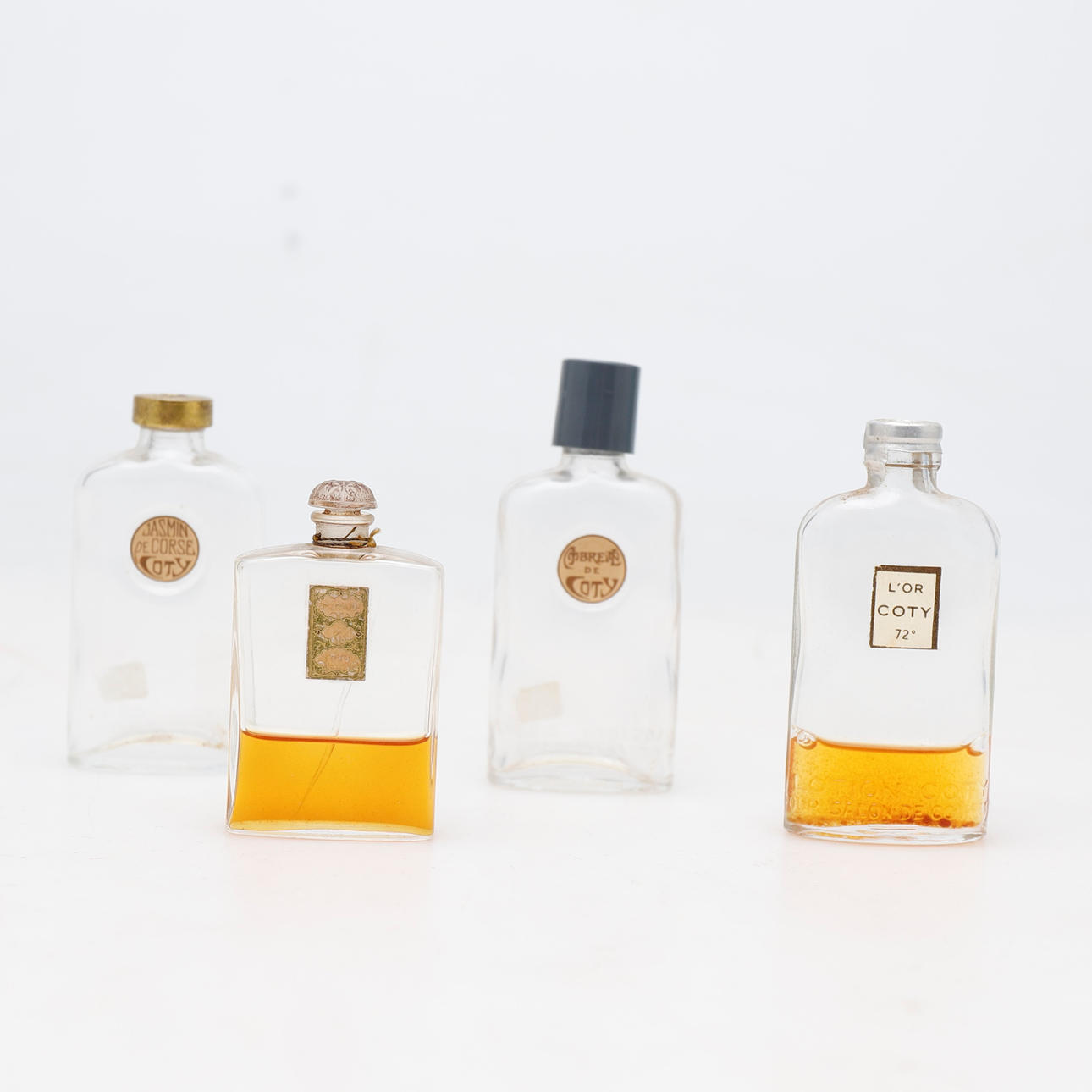 Coty: four glass perfume bottles, circa 1930-40.