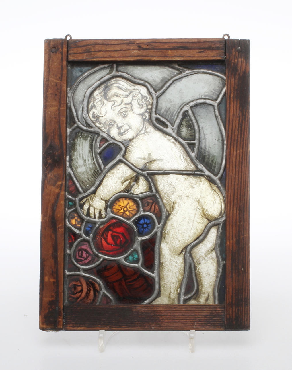 BLYGLASFÖNSTER, i ram, med motiv av pojke.