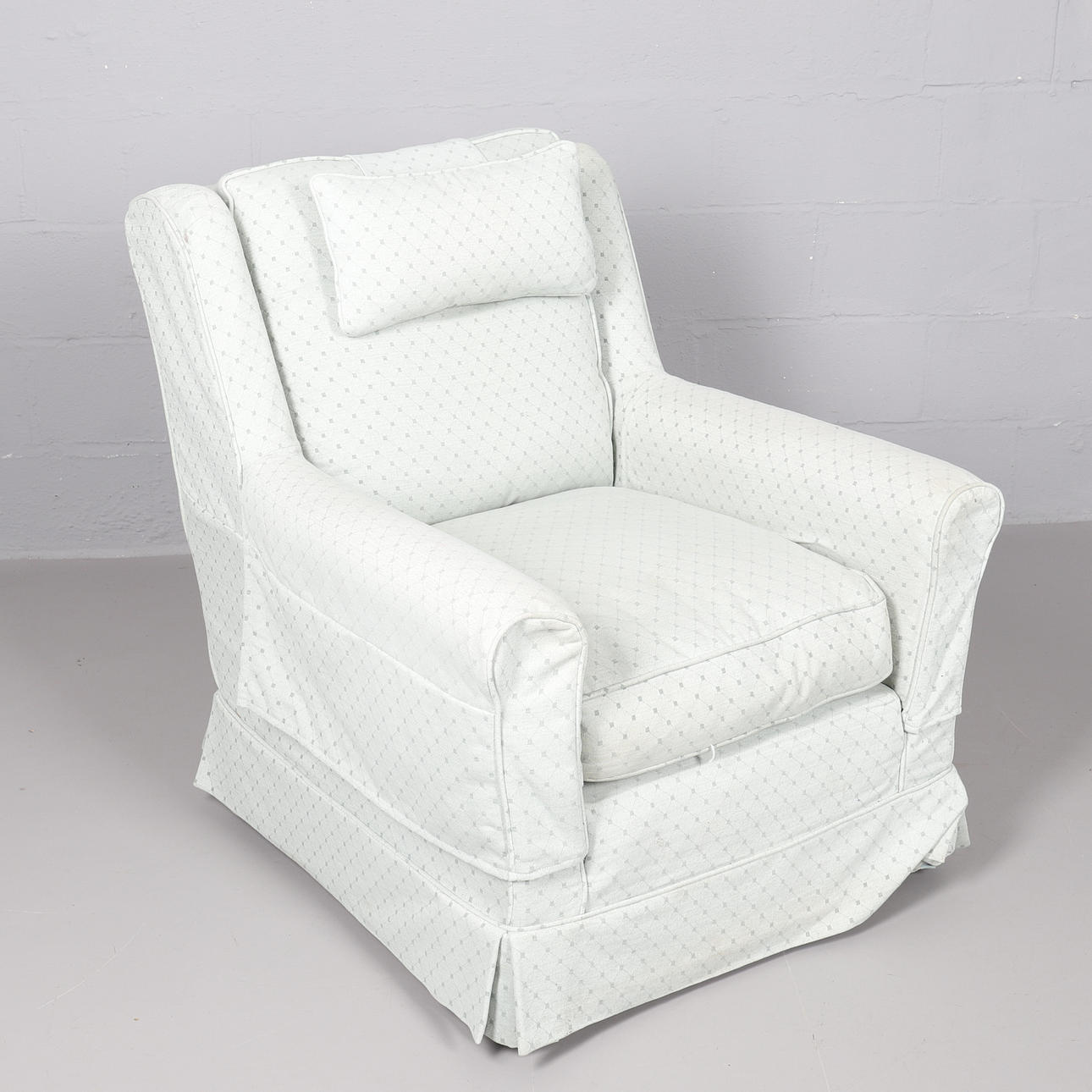 A WESLEY-BARRELL LONG SEAT WINGBACK ARMCHAIR.