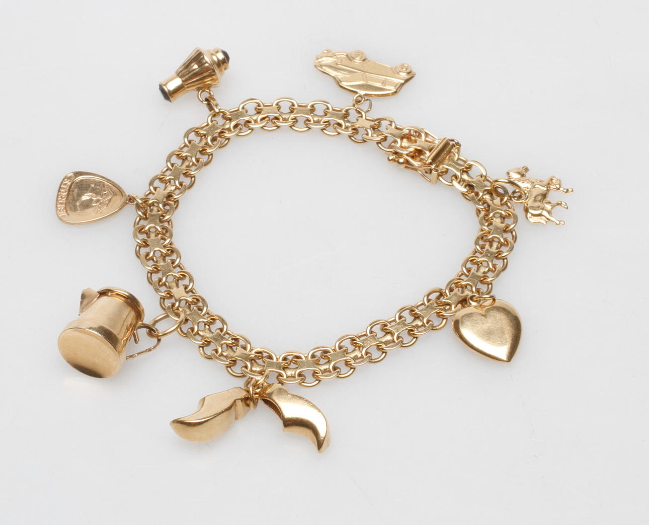 ARMBAND X-LÄNK MED BERLOCKER, 18k guld, total vikt 25,8 gr.