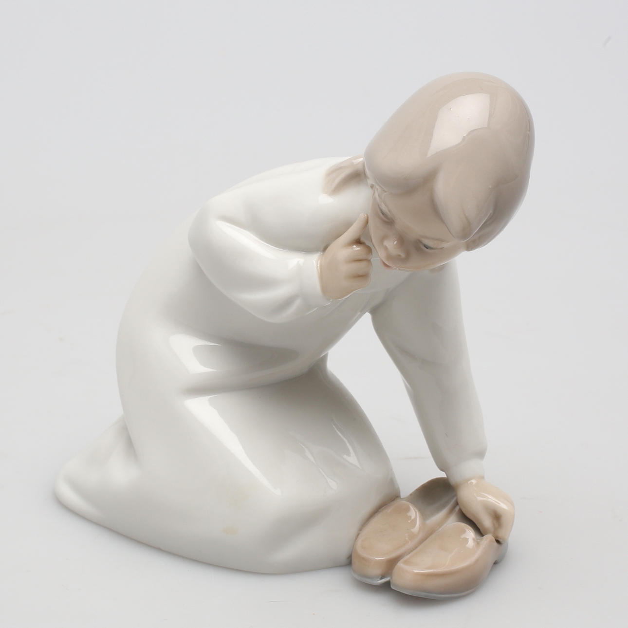 FIGURIN i porslin, Lladro, sittande flicka med skor.