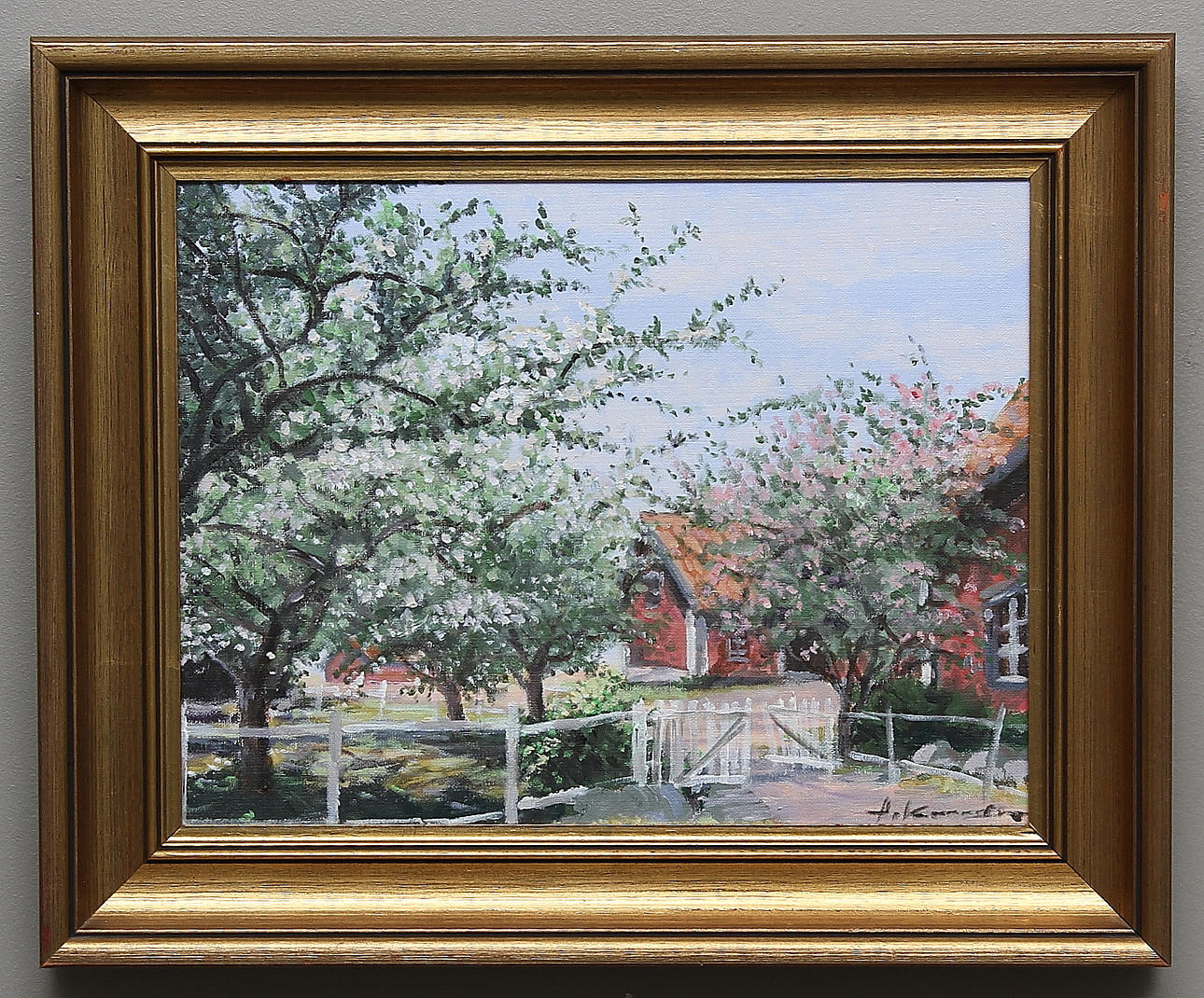ALEXANDER KUNICKI. Rött hus och blommande fruktträd. Olja på duk. Signerad.