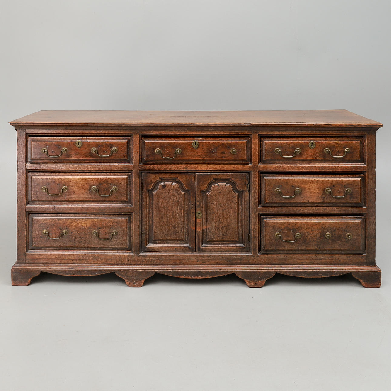 A GEORGE III OAK LOW DRESSER.