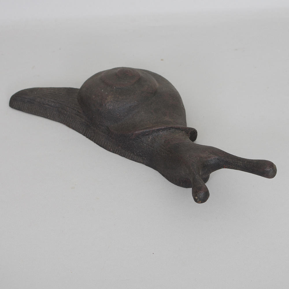 STÖVELKNEKT i form av snigel, gjutjärn, samtida.