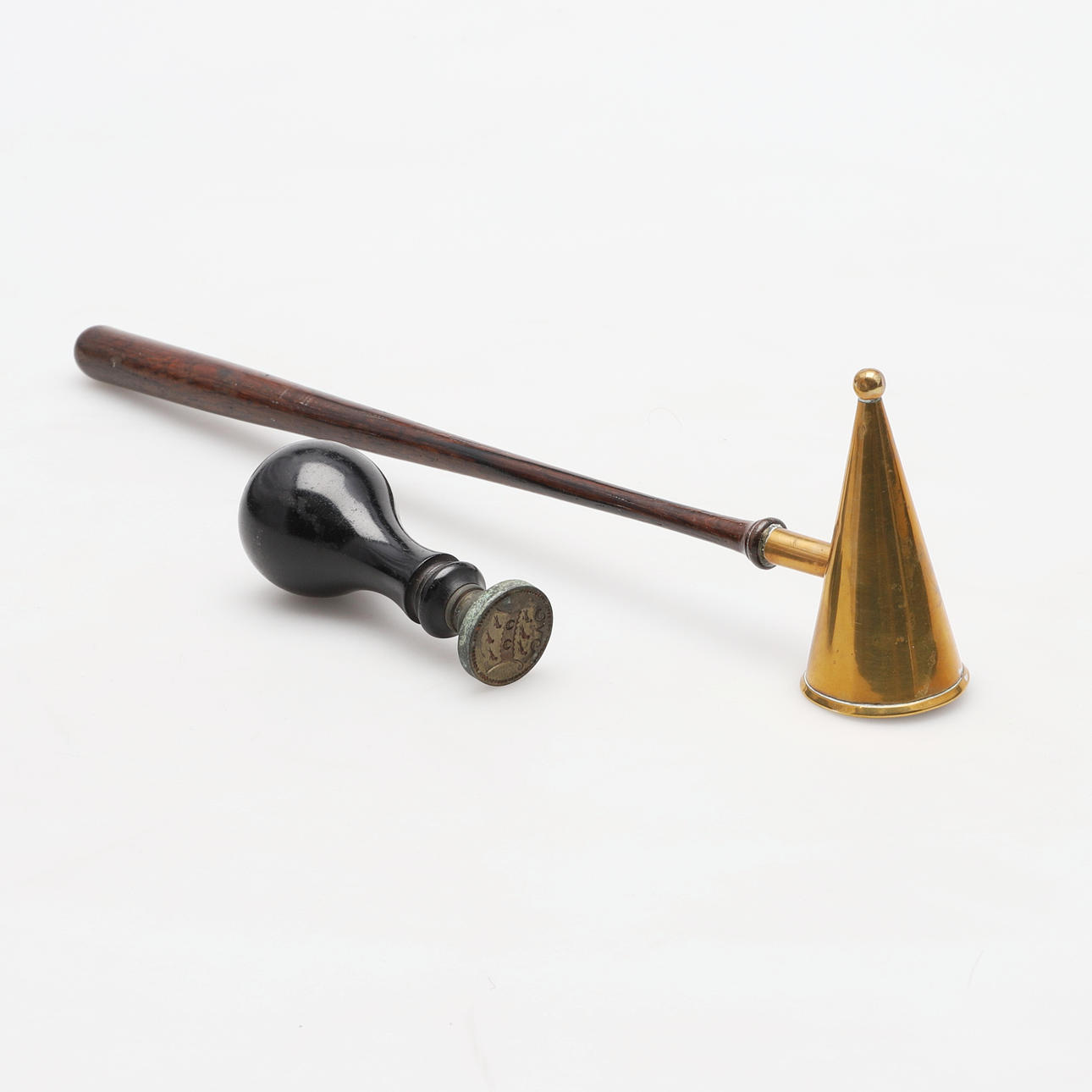A CANDLE SNUFFER AND A DESK SEAL.