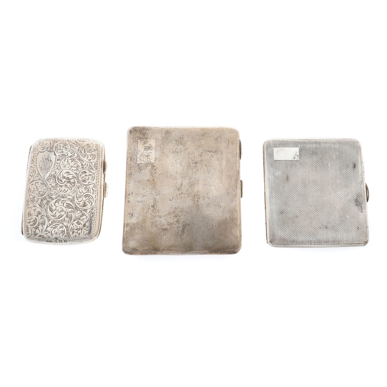 TWO ENGINE TURNED SILVER CIGARETTE CASES AND A VICTORIAN SILVER CIGARETTE CASE.