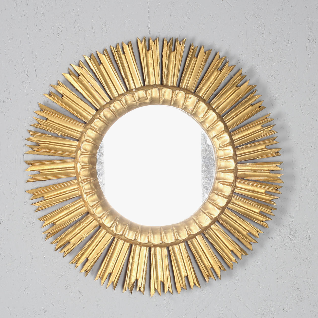 SUN MIRROR, bronzed wood, 20th century.