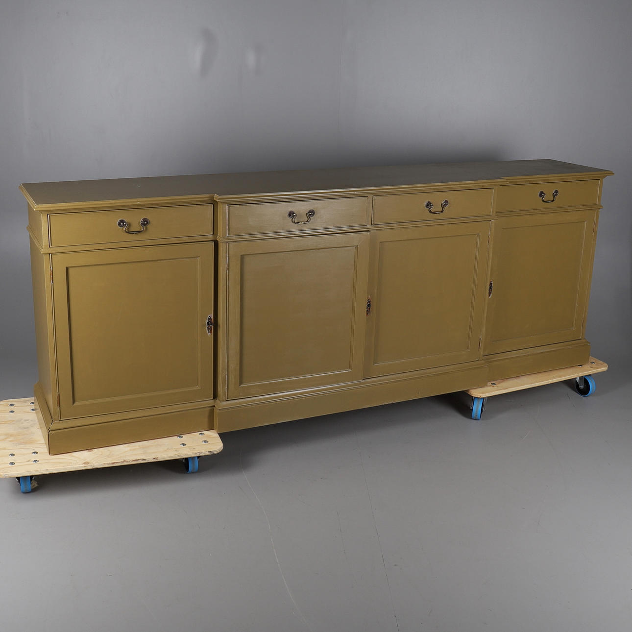 A MODERN OLIVE GREEN PAINTED BREAKFRONT SIDEBOARD.