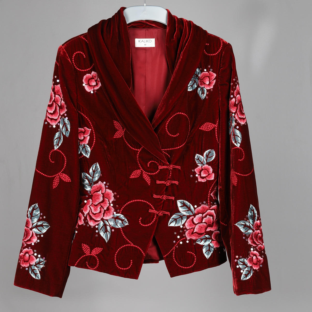 AN EMBROIDERED RED VELVET KALIKO JACKET.
