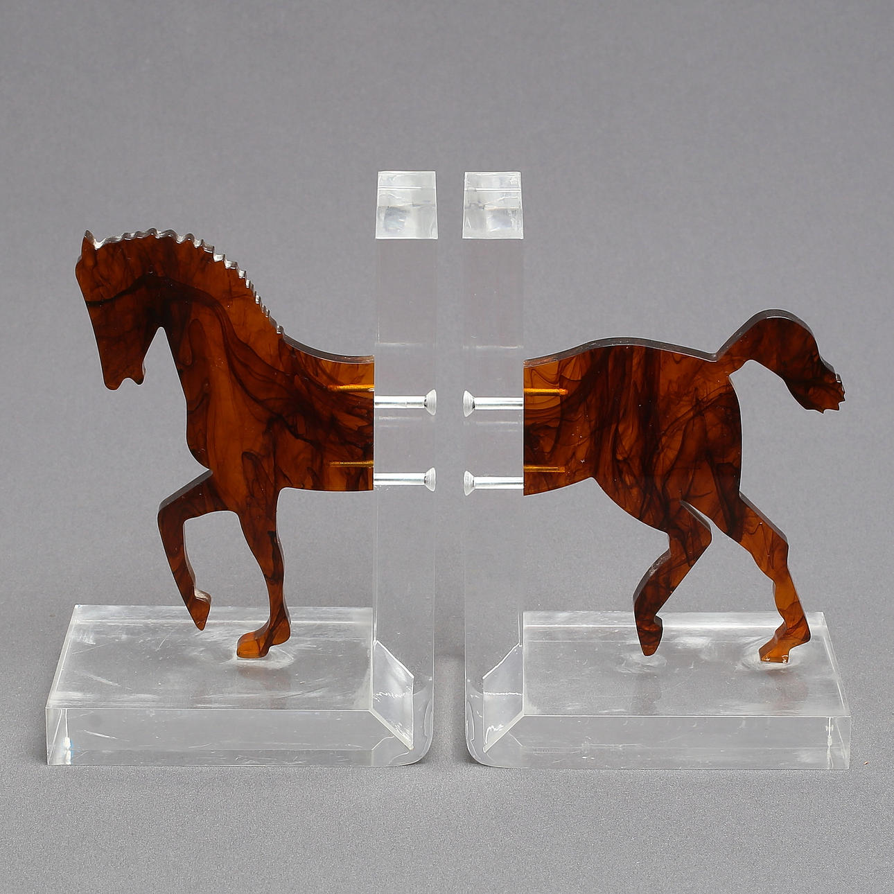SOPORTE PARA LIBROS, 1 par, en forma de caballo, plexiglás.