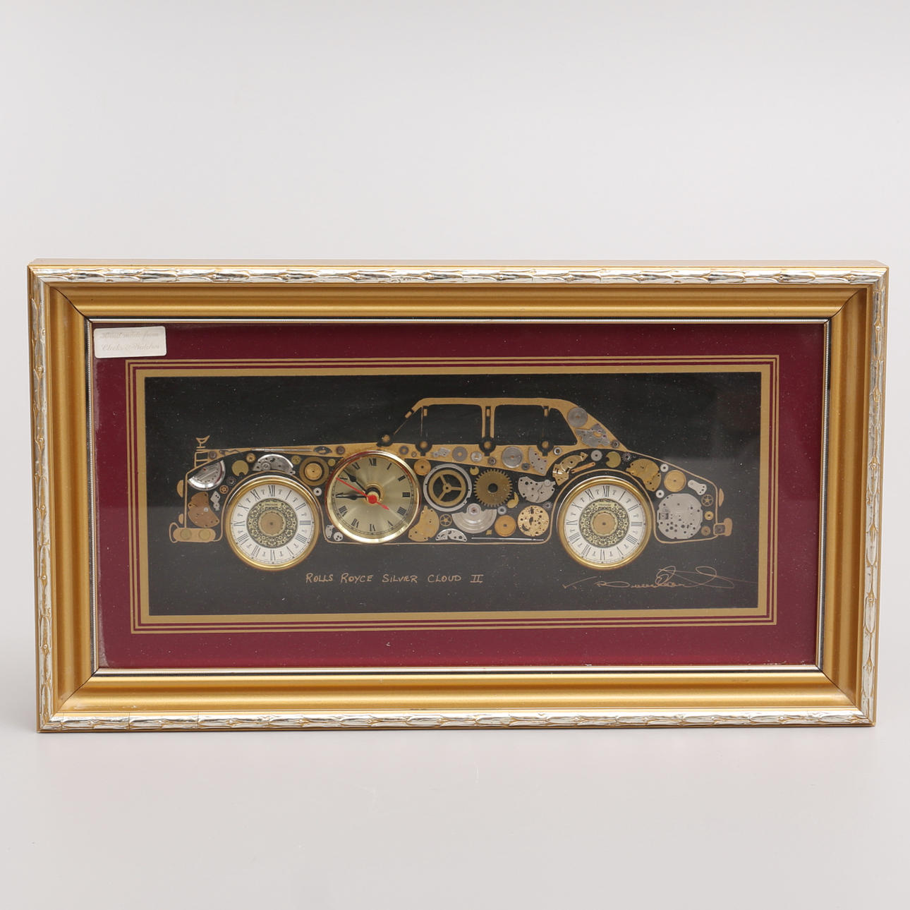 WALL CLOCK, board made of different clock parts, representing RR Silver Cloud, L. Kersh of London.