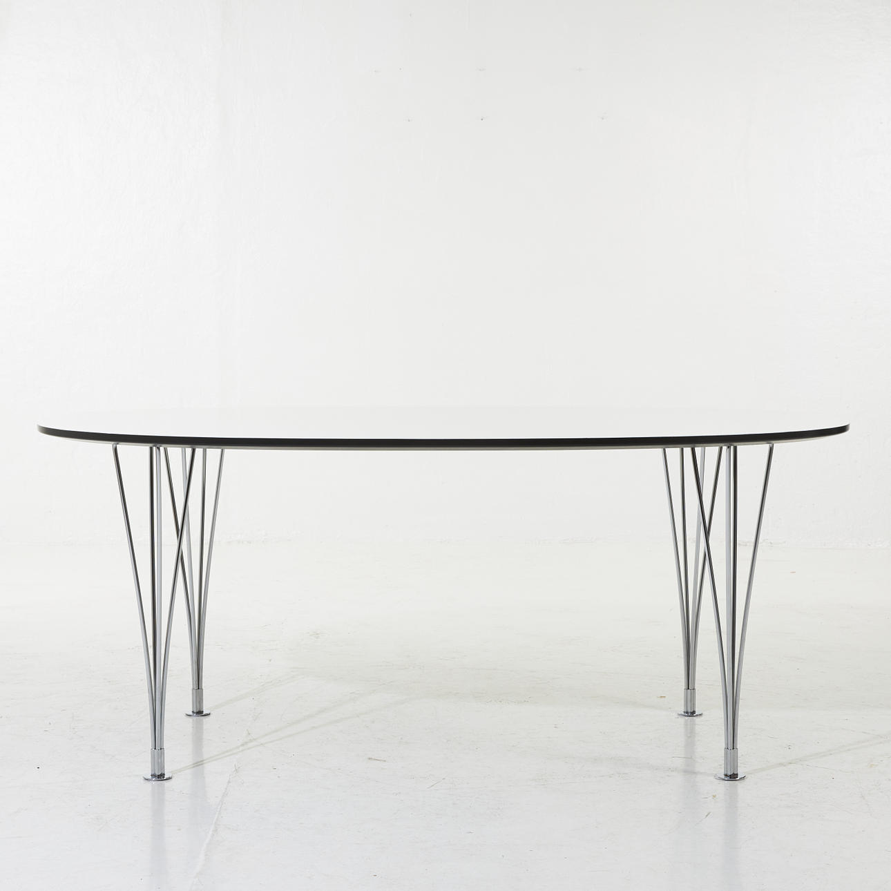 BRUNO MATHSSON. Superellips", dining table, Mathsson International, white lacquered top, 4 chrome legs, black edge, label marked "PIET HEIN BRUNO MATHSSON" as well. "BRUNO MATHSSON INTERNATIONAL MADE IN VÄRNAMO SWEDEN.