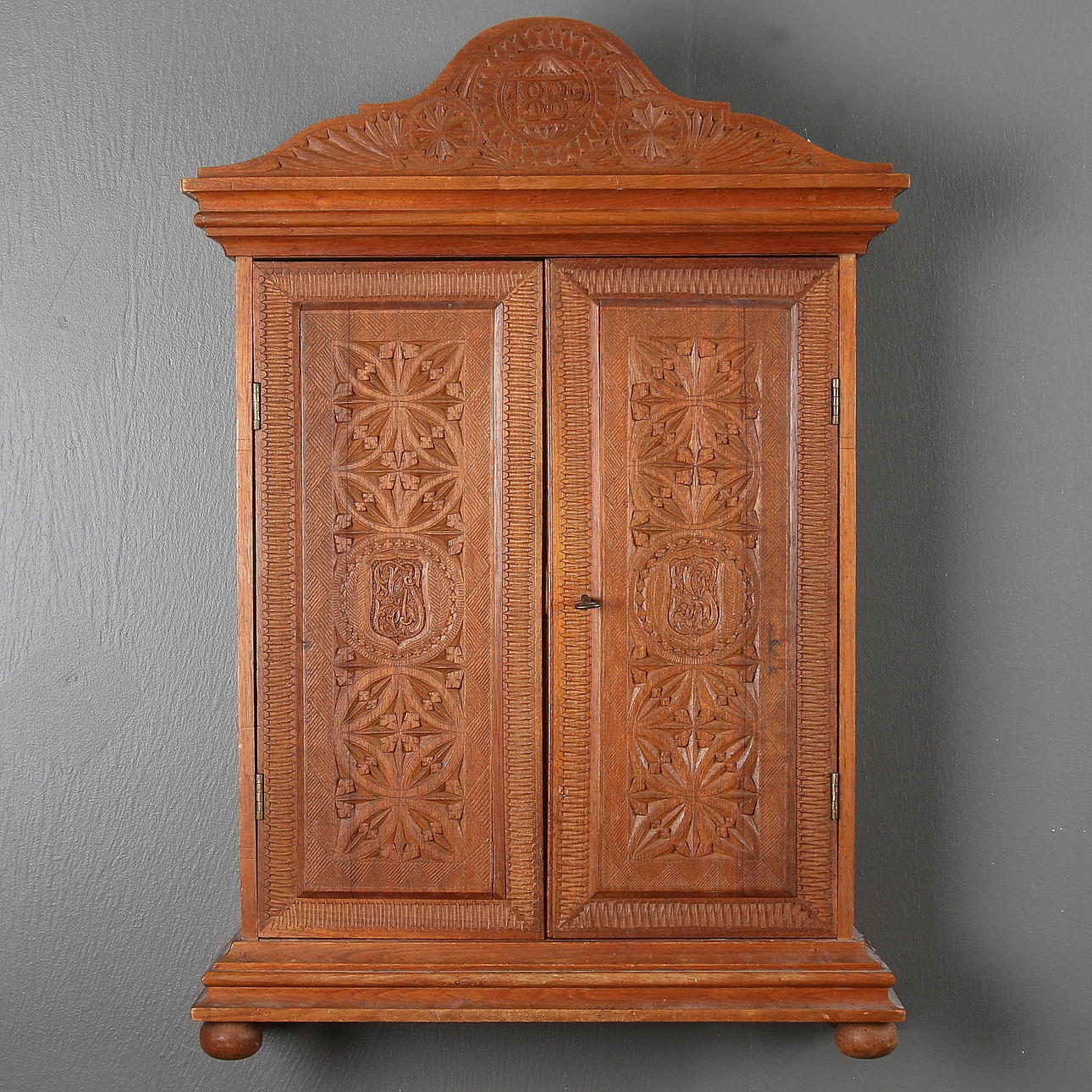 WALL CABINET, notched section, dated, 1882.