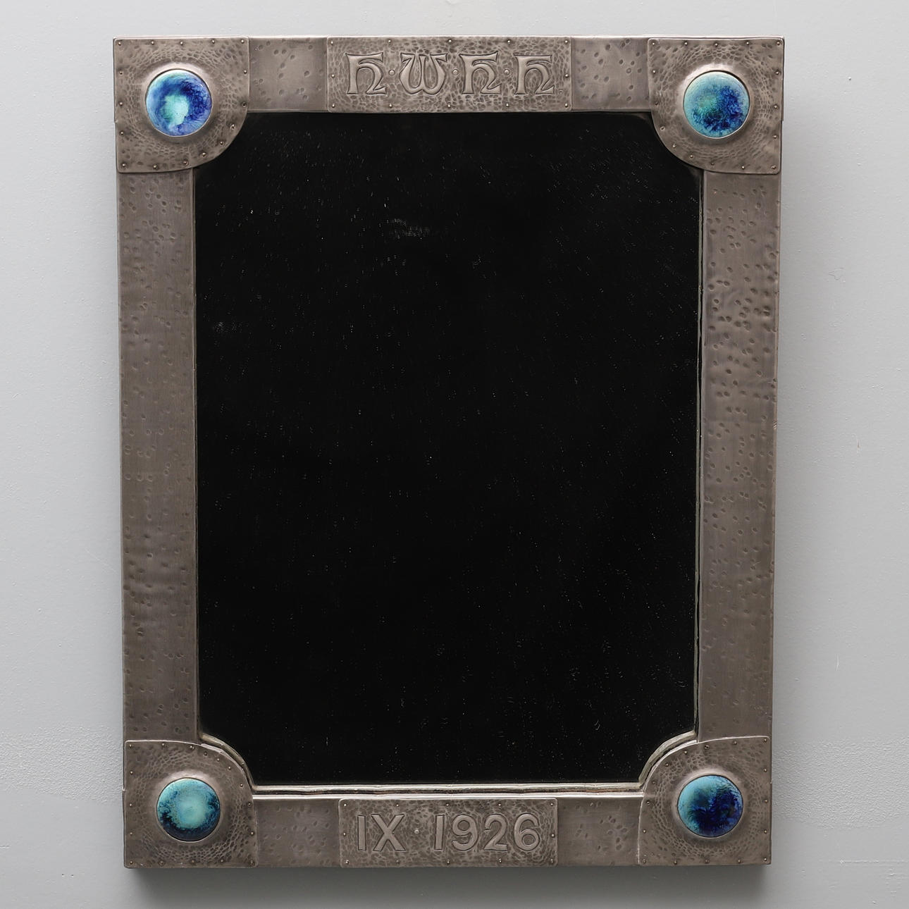 AN ARTS AND CRAFTS PEWTER FRAME RECTANGULAR WALL MIRROR.