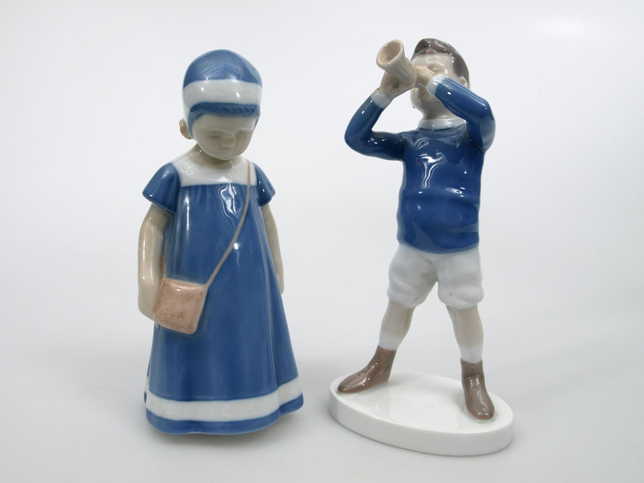 FIGURINER, porslin, 2 stycken, Flicka med väska och Pojke med lur, Bing&Gröndahl.