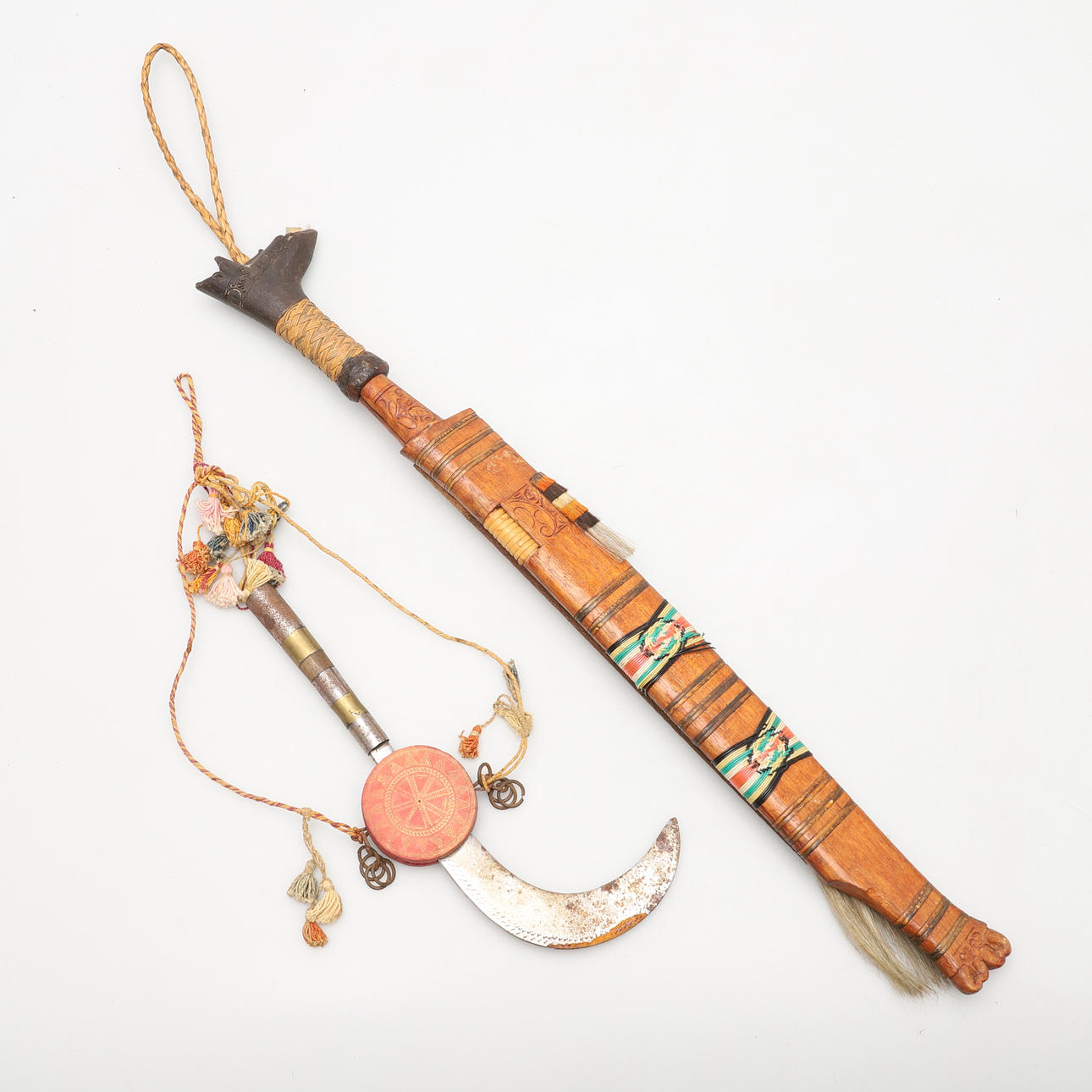 A VINTAGE KAYAN DAGGER AND AN EASTERN SICKLE.