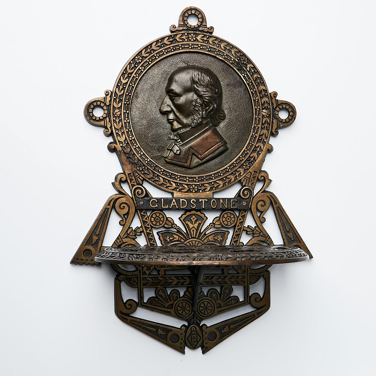 WALL SHELF, bronze, with Gladstone medallion.