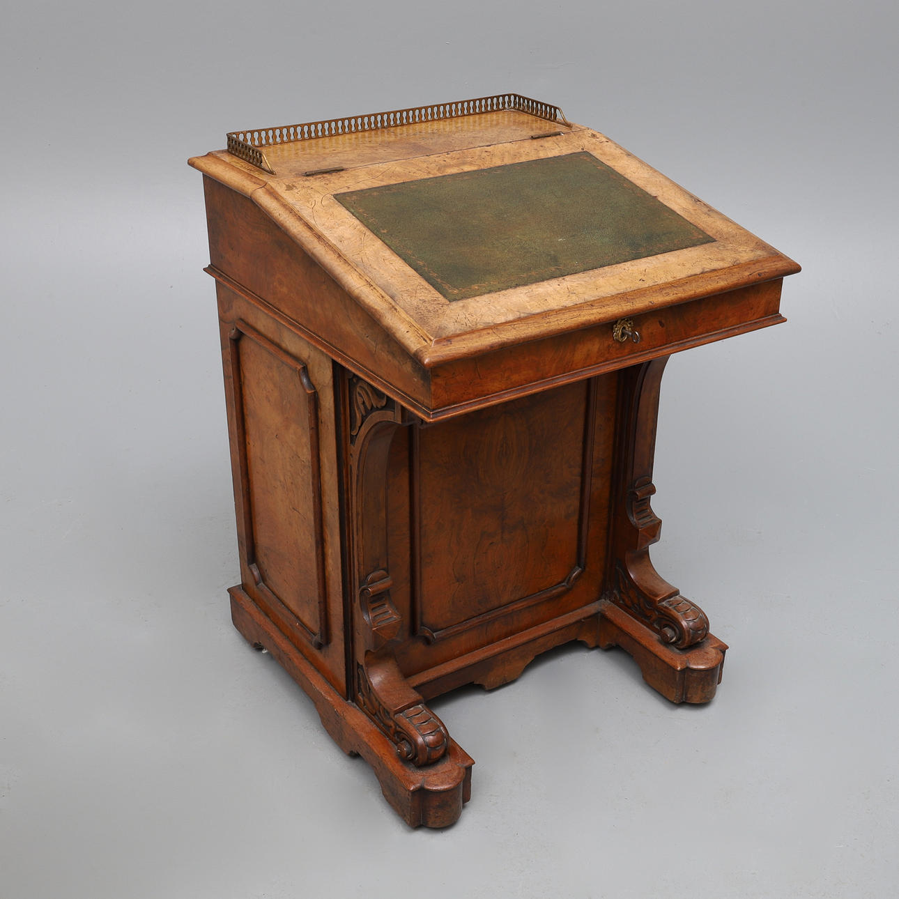 A VICTORIAN FIGURED WALNUT DAVENPORT, CIRCA 1870.