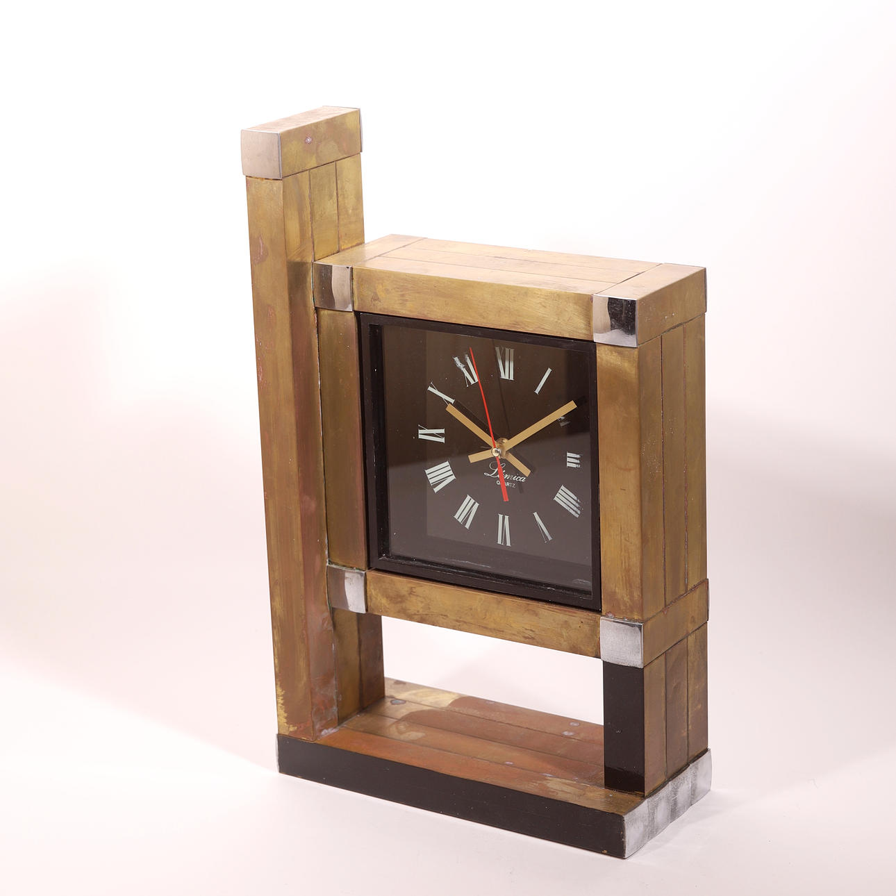 AFTER WILLY RIZZO. TABLE CLOCK, contrasted metals, 70-80 years.