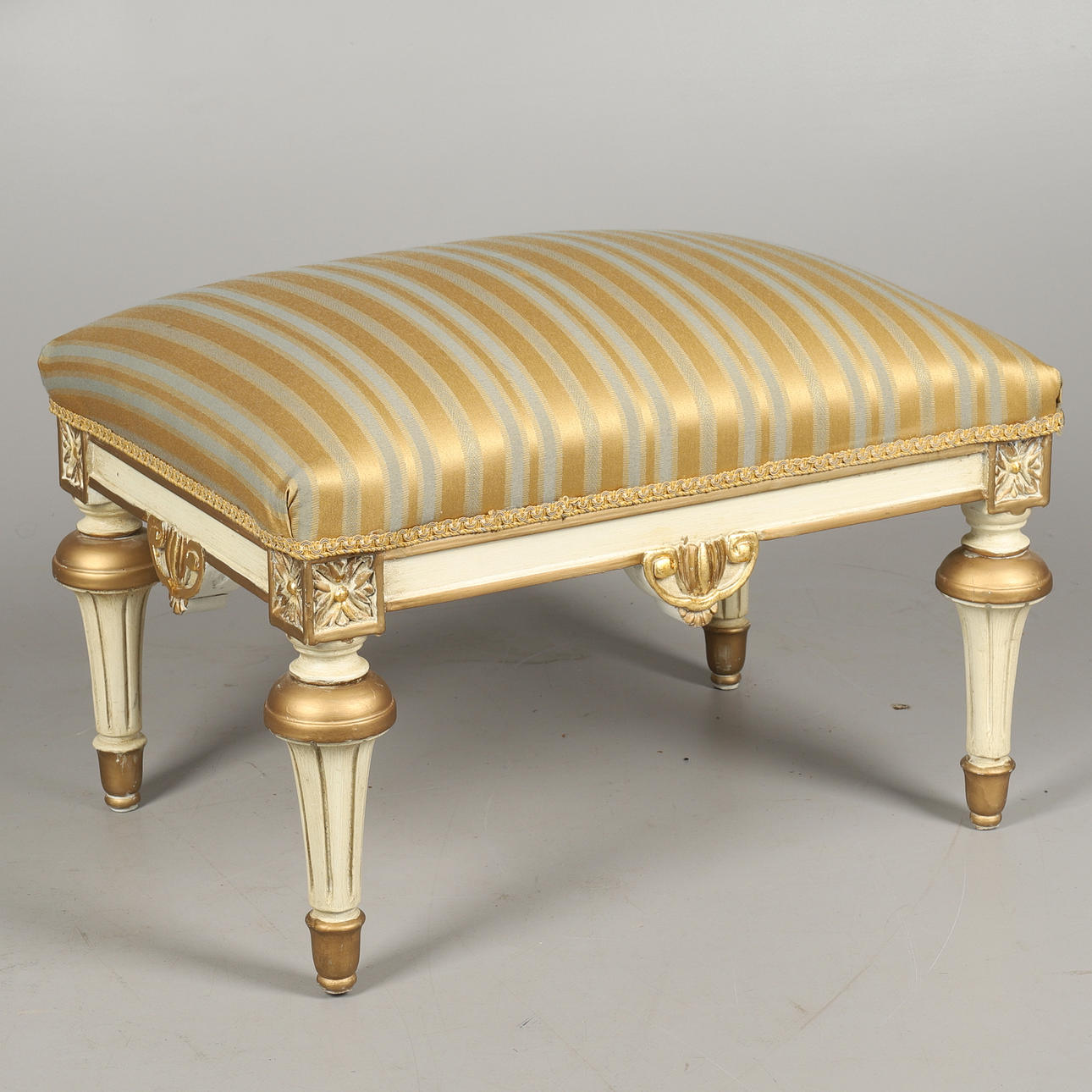 A RECTANGULAR UPHOLSTERED FOOT STOOL IN THE LOUIS XVI TASTE.